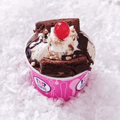 A Brownie Sundae With A Cherry On Top In A Pink Baskin Robbins Cup GIF