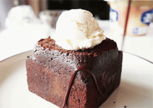 A Brownie With A Scoop Of Ice Cream On Top Of It GIF