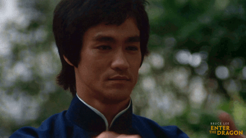 A Bruce Lee Enter The Dragon Poster Shows A Man In A Blue Uniform GIF