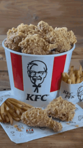 A Bucket Of Kfc Fried Chicken And French Fries On A Table GIF