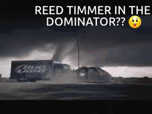 A Bud Light Truck Driving Down A Road With A Tornado In The Background GIF
