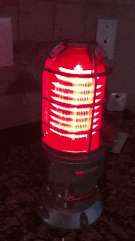 a budweiser light is lit up on a counter