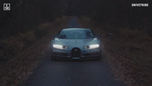 a bugatti chiron is driving down a road with the words drivetribe on the bottom