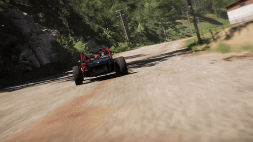 a buggy is driving down a dirt road with trees in the background