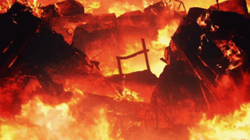 A Building Is On Fire With A Cross In The Middle Of It GIF