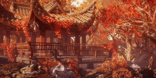 A Building With A Roof That Has Red Leaves Hanging From It GIF