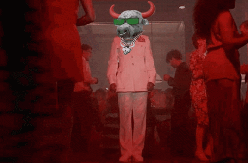 A Bull Wearing Sunglasses And A Necklace Is Dancing In A Crowd GIF