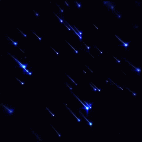A Bunch Of Blue Lights Are Falling In The Dark GIF