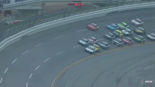 A Bunch Of Cars Are Racing On A Race Track With Nascar Written On The Bottom GIF