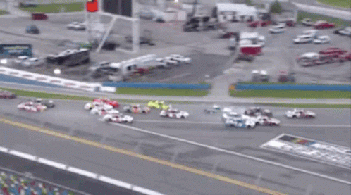 a bunch of cars are racing on a track sponsored by busch coca cola