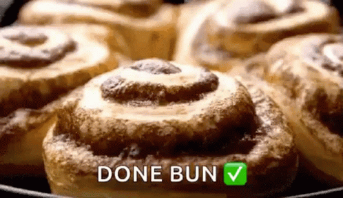 A Bunch Of Cinnamon Rolls In A Skillet With The Words `` Done Bun '' Written On It . GIF