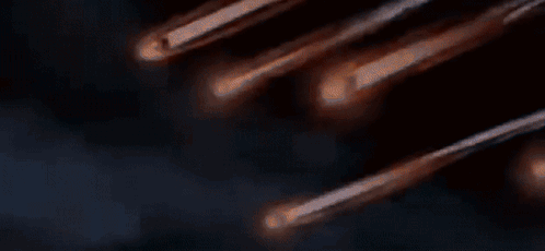 A Bunch Of Comets Are Flying Through The Night Sky GIF