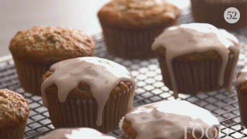 A Bunch Of Cupcakes On A Cooling Rack With The Number 52 On The Bottom Right GIF