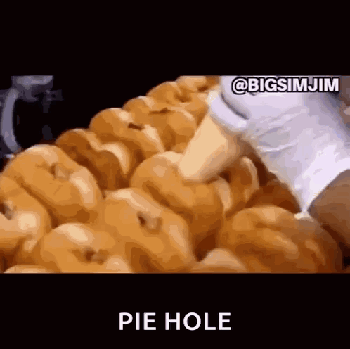 A Bunch Of Donuts Are Sitting On Top Of Each Other With The Words Pie Hole Written In The Corner . GIF