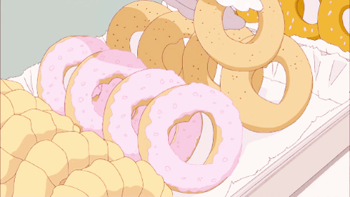 A Bunch Of Donuts Are Stacked On Top Of Each Other On A White Surface GIF