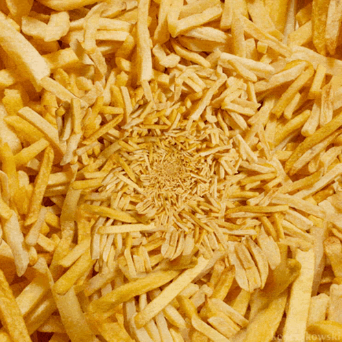 A Bunch Of French Fries Are Scattered In A Circular Pattern GIF