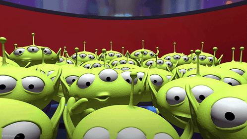 A Bunch Of Green Aliens From Toy Story Are Looking At Something GIF