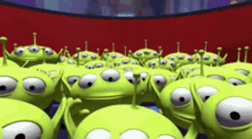 A Bunch Of Green Aliens From Toy Story Are Standing In A Line GIF