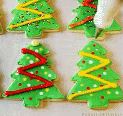 A Bunch Of Green Christmas Trees With Red Yellow And White Decorations GIF