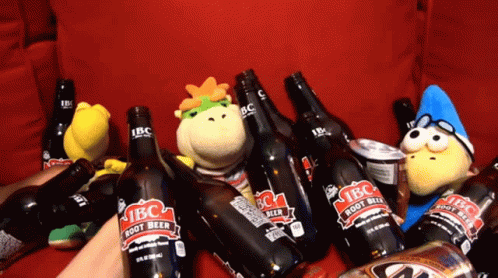 A Bunch Of Ibc Root Beer Bottles On A Couch GIF