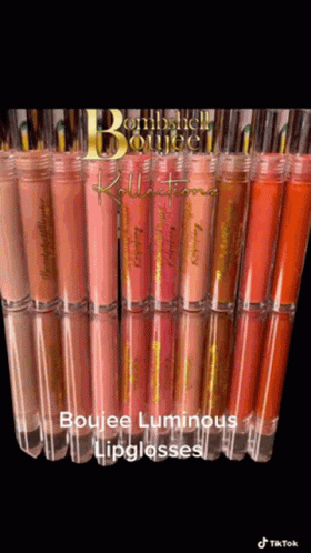 A Bunch Of Lipglosses Are Lined Up On A Table GIF