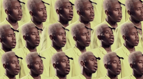 A Bunch Of Men In Yellow Shirts Are Singing Together GIF