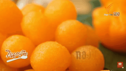 A Bunch Of Oranges Are Sitting On A Table With The Words Thai Pbs Hd On The Bottom GIF