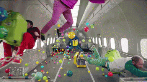 A Bunch Of People Are Flying Through The Air With Balloons And Luggage GIF