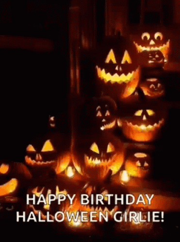 A Bunch Of Pumpkins Are Sitting Next To Each Other In A Dark Room . GIF