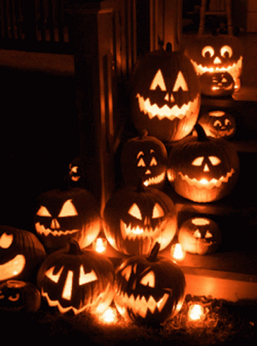 a bunch of pumpkins with faces carved on them