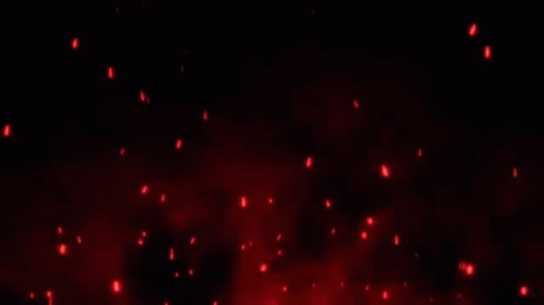 A Bunch Of Red Sparks Are Flying In The Air On A Black Background . GIF