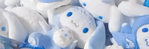 A Bunch Of Stuffed Animals Laying On Top Of Each Other . GIF