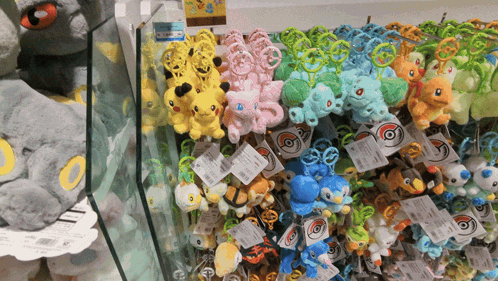 A Bunch Of Stuffed Pokemon Are Displayed On A Shelf In A Store GIF