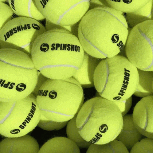 A Bunch Of Tennis Balls With Spinshot On Them GIF