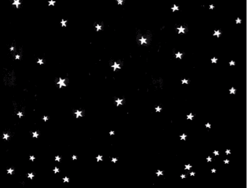 A Bunch Of White Stars Are Falling In The Night Sky On A Black Background . GIF
