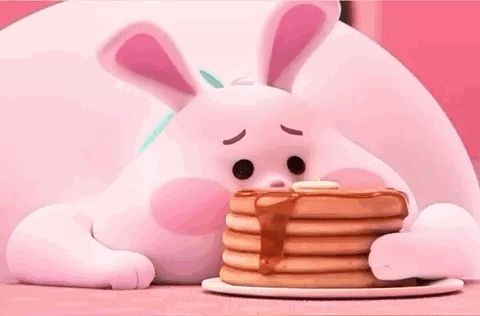 A Bunny Is Eating A Stack Of Pancakes With Syrup . GIF