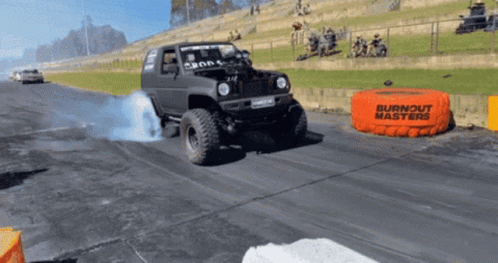 A Burnout Masters Bag Is On The Side Of A Road GIF