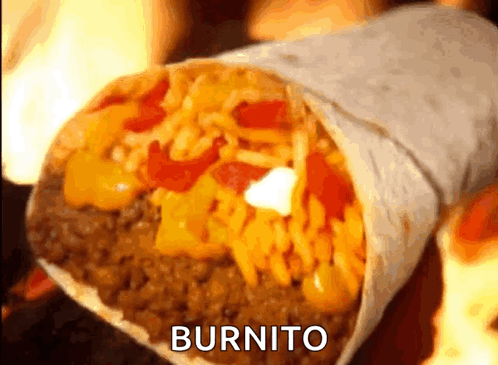 A Burrito Is Sitting On A Table With Flames In The Background .. GIF