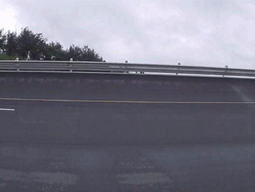 A Bus Is Driving Down A Road And The Word Mercedes Is On The Side GIF