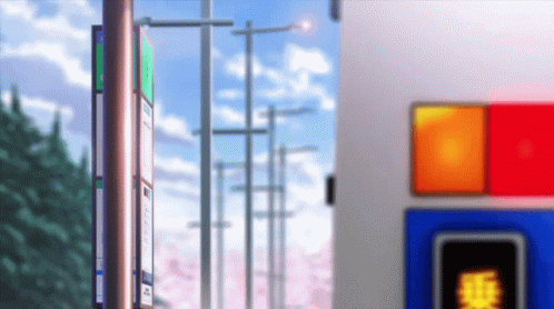 A Bus Stop With Cherry Blossoms In The Background And A Red Light GIF