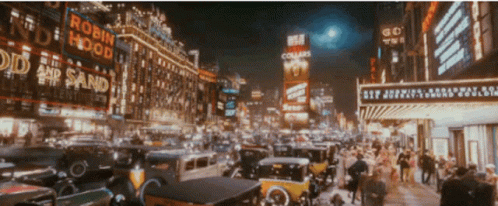 A Busy City Street With A Robin Hood Sign GIF
