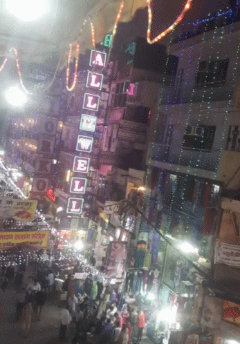 A Busy Street With A Sign That Says A L E W E L On It GIF