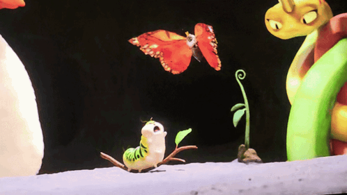 A Butterfly Is Flying Over A Caterpillar With A Green Plant In The Background GIF