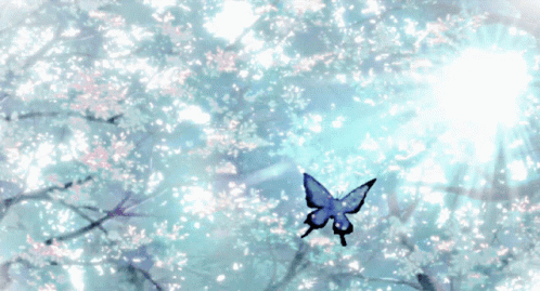 A Butterfly Is Flying Through A Tree With Flowers On It GIF