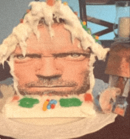 a cake that looks like a man 's face with a beard on it