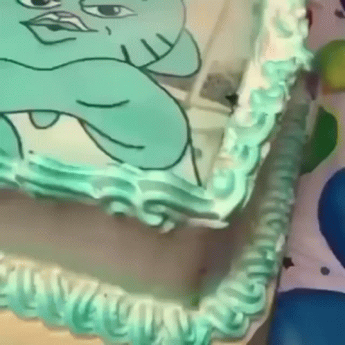A Cake With A Picture Of A Cartoon Character On It . GIF