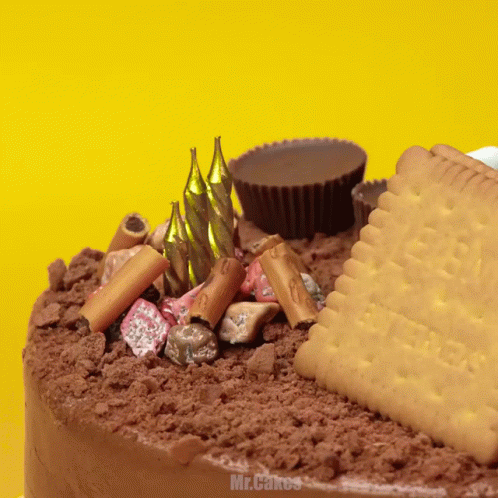 A Cake With Candles And A Cookie That Says Butter GIF