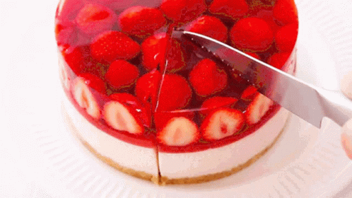 A Cake With Strawberries And Jelly Is Being Sliced By A Knife GIF