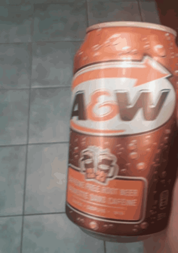 A Can Of A&w Root Beer Is Being Held By Someone GIF