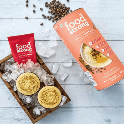 A Can Of Food Strong Daily Protein Is Next To A Cup Of Coffee GIF